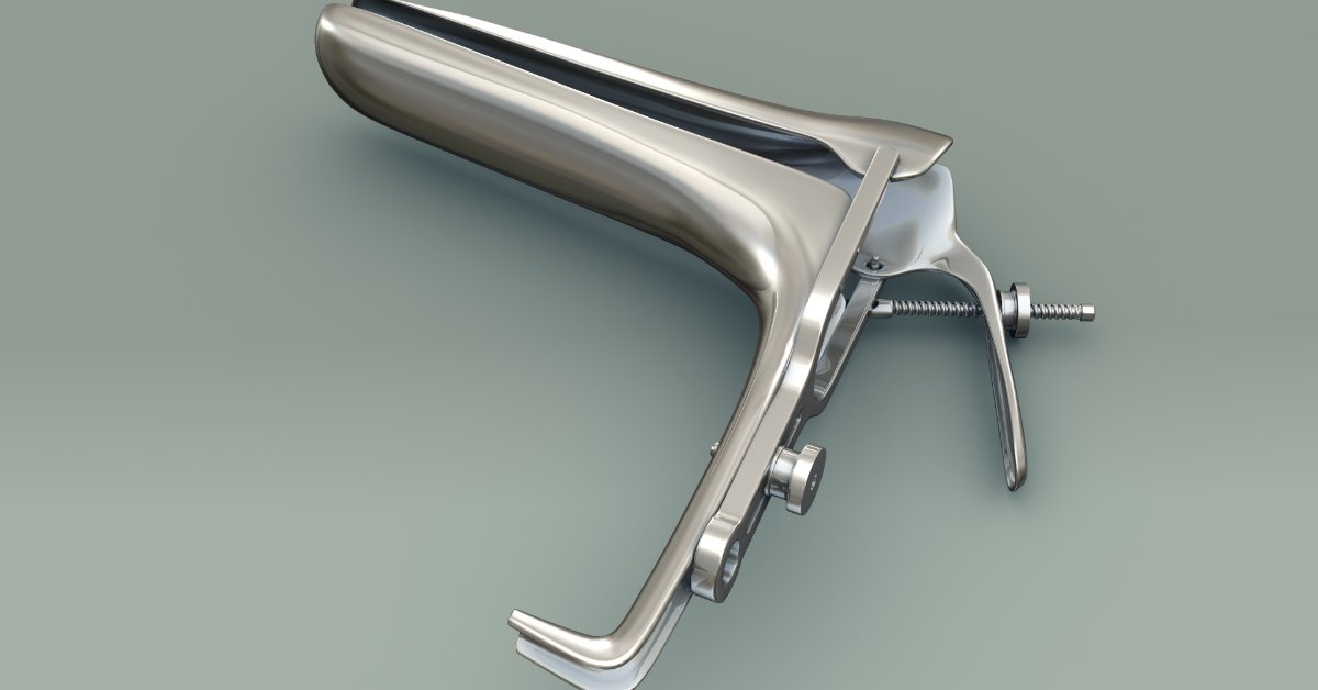 Cleaning and Sterilization Tips for Reusable Vaginal Specula A close-up view shows a metal vaginal speculum sitting alone on a gray background. The speculum is closed.