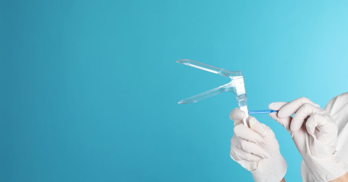When To Replace Vaginal Specula in Your Practice A person wearing white latex gloves is holding a plastic speculum open in front of a teal background.