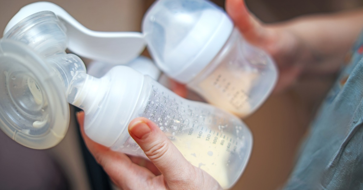 A close-up view shows a person holding a baby bottle containing breast milk and a pump that contains breast milk.